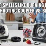 A smoking blender base showing a melted drive coupler next to an opened blender with a broken motor belt, explaining why a blender smells like burning rubber.