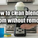 Person running water into a clear pitcher to show how to clean blender bottom without removing the blade assembly.
