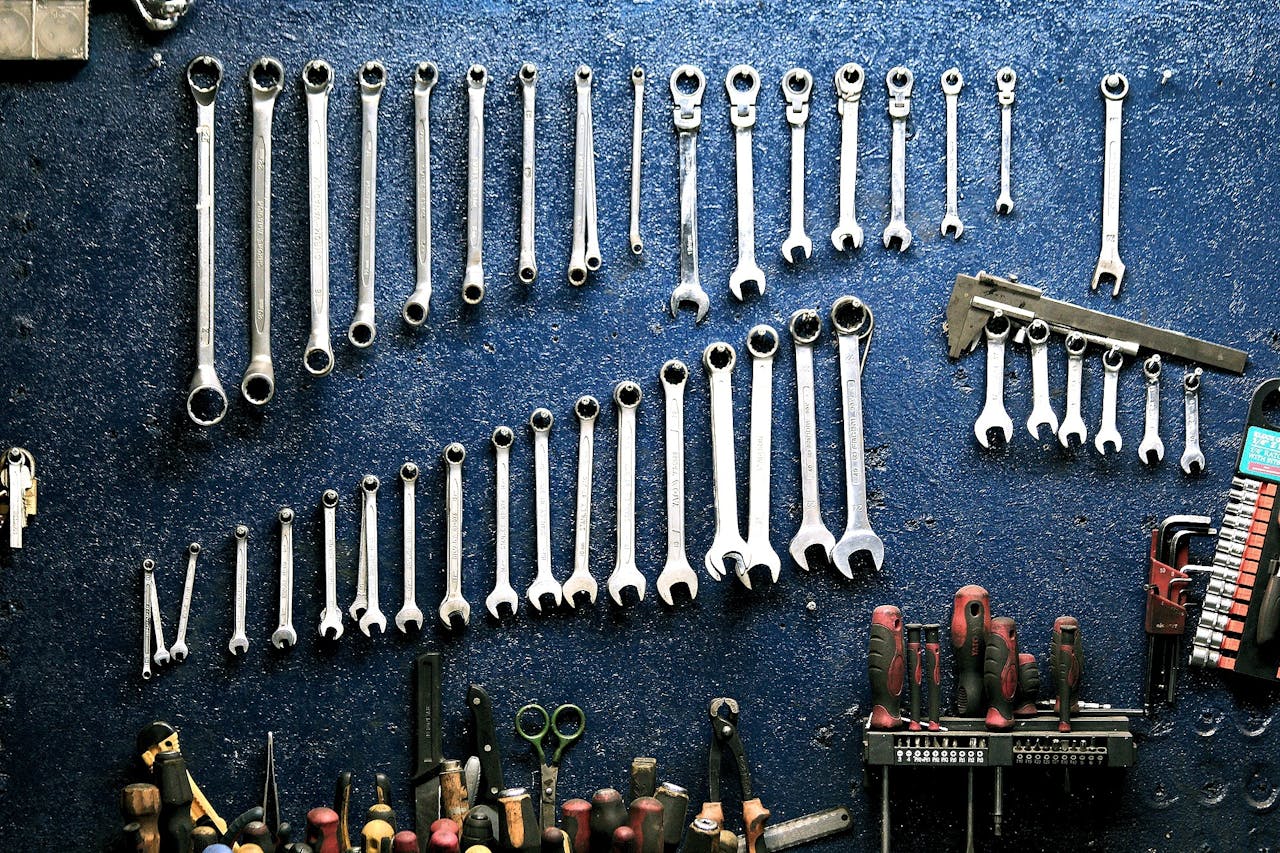 about-me-img Neatly arranged wrenches and tools on a workshop wall, ideal for mechanics.