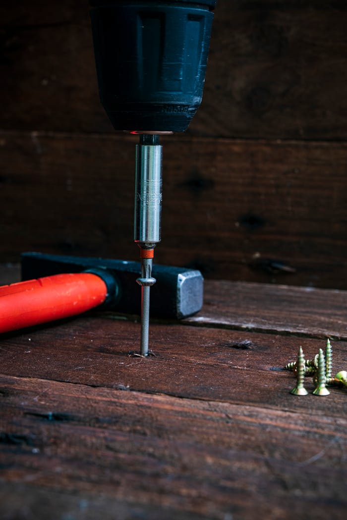 service-01 Close-up of a drill in action on wooden surface, ideal for DIY and carpentry themes.