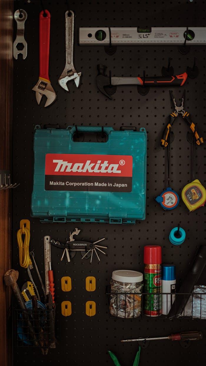 why-choose-me Neatly arranged tools on pegboard wall with a Makita toolbox in focus.
