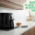 Black air fryer sitting on a silicone heat mat on a white counter, showing where to place air fryer in kitchen for safety.