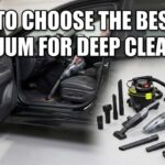 A collection of cordless and corded car vacuums with various attachments like crevice tools and hoses sitting next to an open car door in a garage.