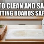 A wooden and a plastic cutting board on a kitchen counter with lemons, salt, white vinegar, and hydrogen peroxide for cleaning.