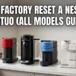 A row of different Nespresso Vertuo coffee machines on a white kitchen counter with the text How to Factory Reset a Nespresso Vertuo (All Models Guide).