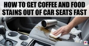 A hand blotting a fresh coffee spill on a gray cloth car seat using white paper towels next to a tipped-over silver travel mug.