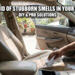 A person cleaning tan car fabric seats with a white cloth and baking soda to show how to get rid of stubborn smells in your car interior.