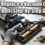 Hands wearing gray gloves putting a new drive belt on an open vacuum cleaner next to simple hand tools.