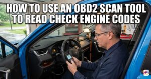 Man sitting in a blue car using an OBD2 scan tool to read check engine codes in a garage.