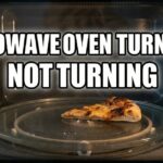 A microwave oven interior showing a single slice of pizza on a glass turntable with bold white text overlay reading "MICROWAVE OVEN TURNTABLE NOT TURNING."