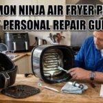 A man in a blue work shirt cleaning a Ninja air fryer heating coil with a toothbrush on a kitchen counter. The text "FIX COMMON NINJA AIR FRYER PROBLEMS" is visible in Impact font.