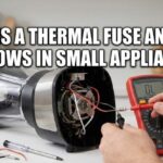 Person testing a tiny thermal fuse inside a blender motor with a red digital multimeter, illustrating What Is a Thermal Fuse and Why It Blows in Small Appliances.