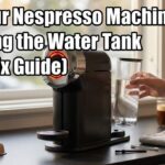 A person holding a clear water tank next to a black Nespresso coffee maker. Bold text reads Why Your Nespresso Machine Is Not Detecting the Water Tank (Quick Fix Guide).