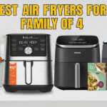 A horizontal banner with the title "BEST AIR FRYERS FOR FAMILY OF 4" in large yellow text. It features four different air fryer models in a kitchen setting: a Chefman, an Instant Vortex Plus, a Cosori with a recipe booklet, and a Ninja Foodi. All have digital displays. On the right, there is an "Amazon Price" button with a pointer. A small "HSG" logo is in the bottom right corner.
