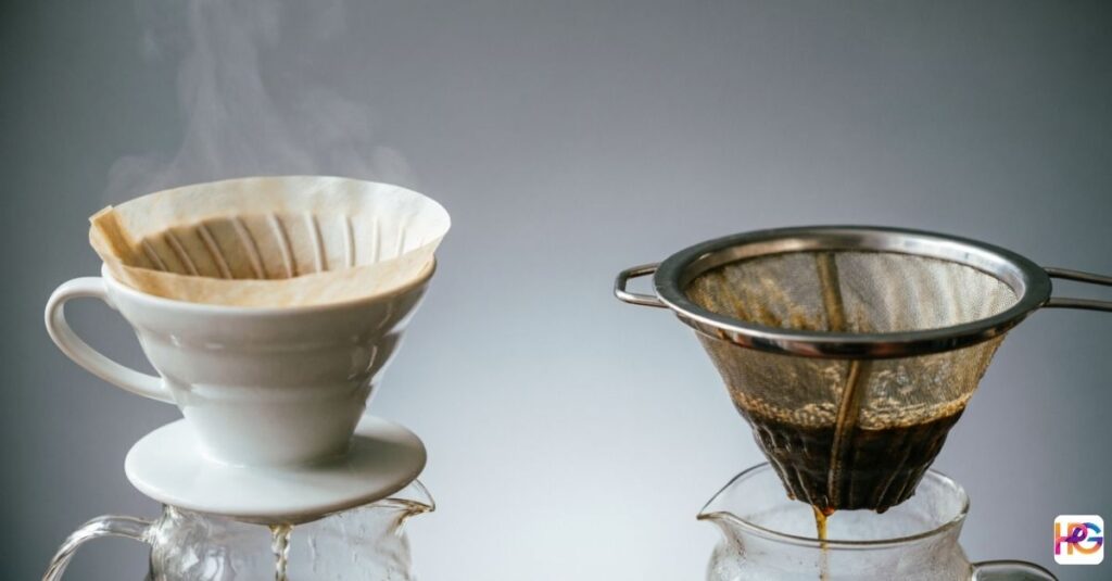 Cone dripper with paper filter and metal reusable filter both brewing coffee into glass carafes with steam rising