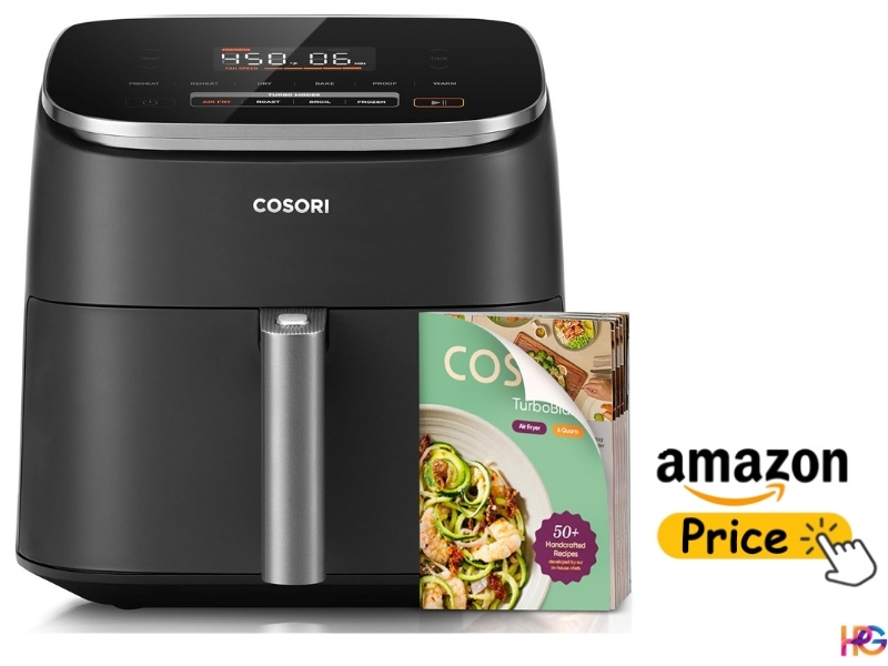 Cosori air fryer with digital display and recipe book placed in front, Amazon price label on the side