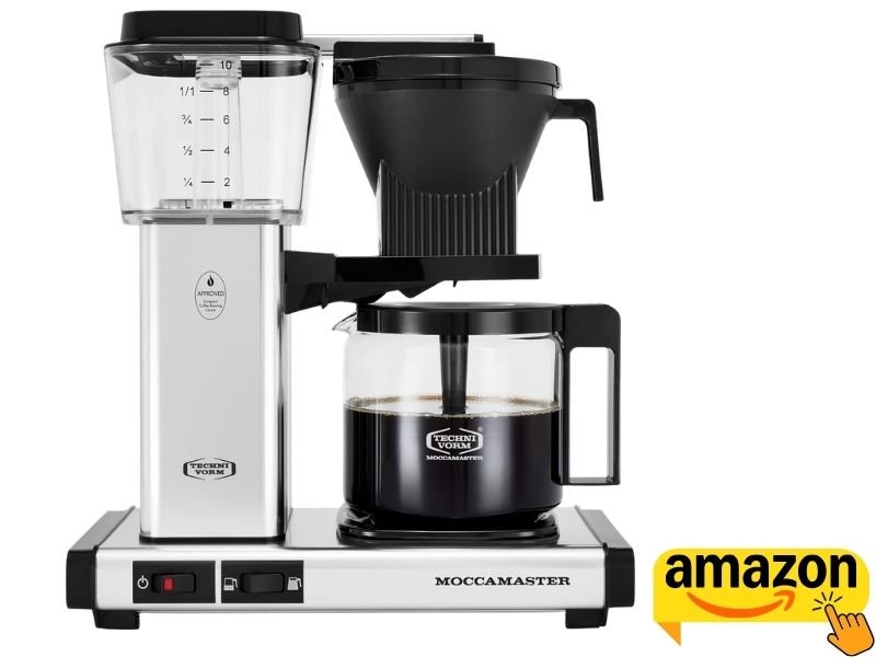 Technivorm Moccamaster KBGV Select drip coffee maker in brushed silver with clear water reservoir and glass carafe filled with dark brewed coffee.