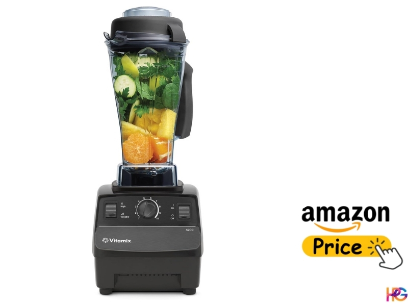 Vitamix 5200 blender featuring its iconic tall pitcher filled with greens and citrus fruits.