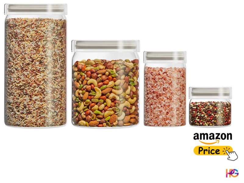 A row of four cylindrical clear glass canisters in descending sizes filled with wild rice, mixed nuts, pink Himalayan salt, and peppercorns.