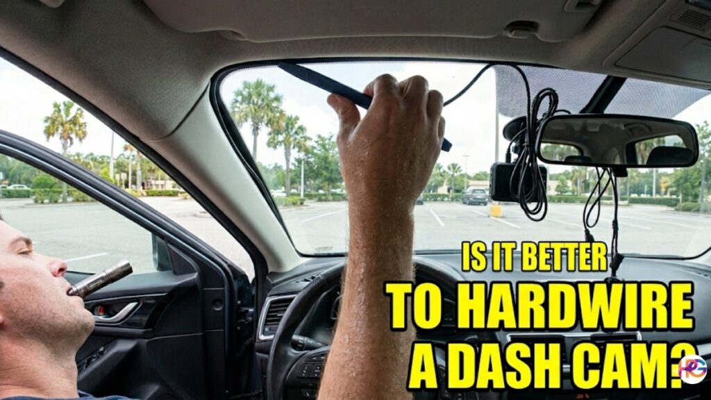 A man inside a car sweating while prying at the windshield trim to hide dash cam wires and holding a flashlight in his mouth.