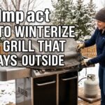An American woman in a winter hat and gloves securing a canvas cover onto an outdoor gas grill on a snowy wooden deck.