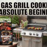 A clean product image on a patio table features a stainless steel gas grill on the right with vegetable skewers on the grate. On the left are four stacked best gas grill cookbooks including covers for "Meathead," "Weber’s Ultimate Grilling," "Master of the Grill," and "The Barbecue! Bible." Large, white Impact font text at the top reads, "BEST GAS GRILL COOKBOOK FOR ABSOLUTE BEGINNERS."