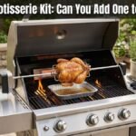 A modern stainless steel gas grill on an outdoor patio with a whole chicken cooking on a rotisserie spit over an open flame, featuring a drip pan underneath and the text "Gas Grill Rotisserie Kit: Can You Add One to Any Grill?" at the top.