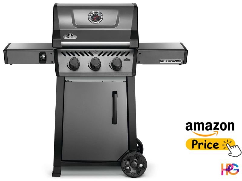 A high-quality grey-bodied Napoleon Freestyle 365 3-burner gas grill is shown on a grey cabinet base with large wheels. It features stainless steel side tables, a lid thermometer, and a prominent 'Napoleon' logo. An 'Amazon Price' graphic with a hand icon is in the lower right.