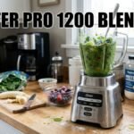A shot of the Oster Pro 1200 Blender mixing a green smoothie in a kitchen setting with fruit and supplements in the background and the text "OSTER PRO 1200 BLENDER" prominently displayed at the top.