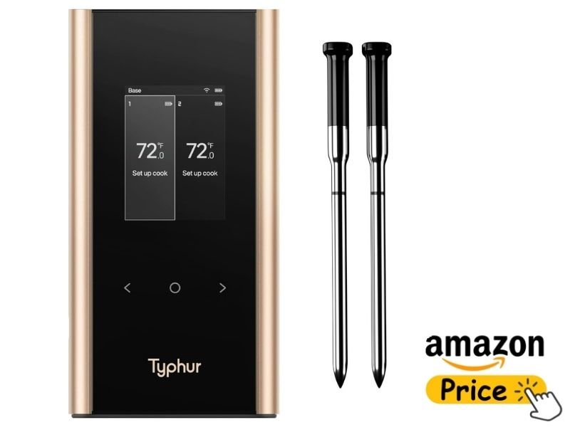 The Typhur Sync Gold wireless meat thermometer set against a clean white background. It includes a sleek, black vertical charging base with gold side panels and a digital display screen showing internal temperatures, accompanied by two stainless steel probes with black tips. A yellow "Amazon Price" button graphic sits in the bottom right corner.