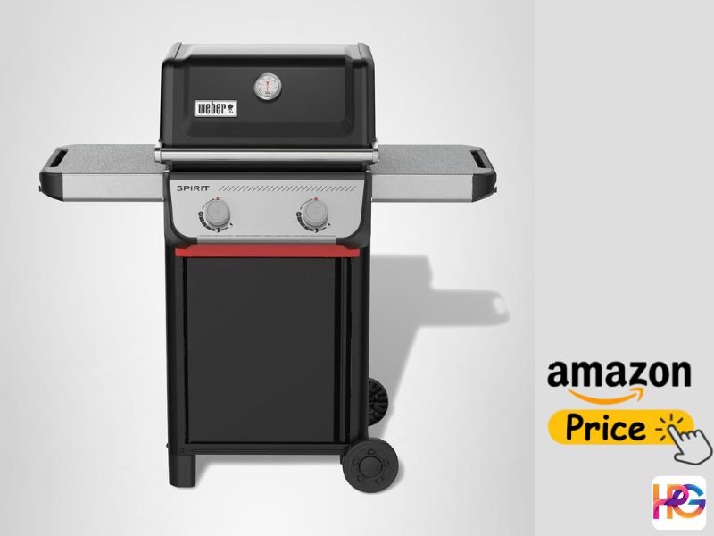 A black Weber Spirit II E-210 2-burner gas grill is shown standing upright with its lid closed. It features a black hood with a thermometer, two control knobs, red trim below the knobs, grey open-cart side tables, and two wheels. An 'Amazon Price' graphic with a hand icon is in the lower right.
