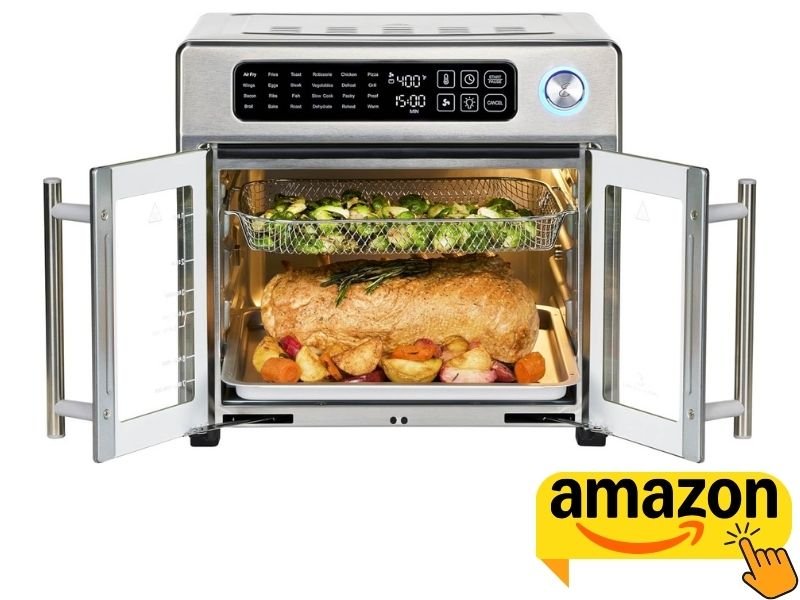 Open French door air fryer oven cooking a roast dinner with vegetables and roasted Brussels sprouts inside.