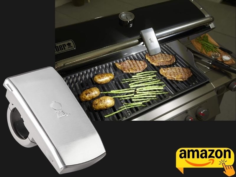 Weber Grill 'N Go Light attached to a barbecue grill for nighttime cooking.